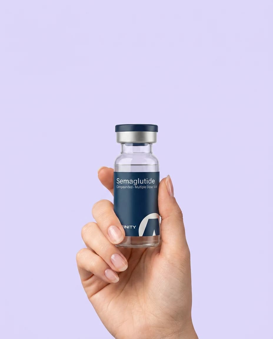 A hand holding an Affinity compounded Semaglutide vial